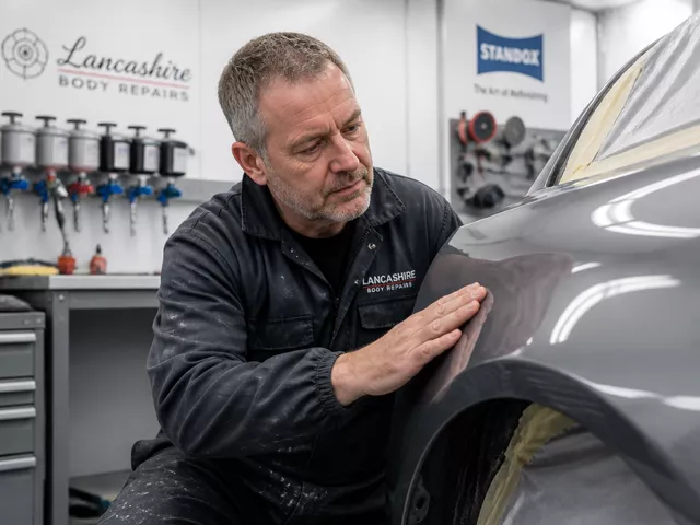 Barry Ackerley inspecting vehicle body repair quality at Autoline workshop in Bacup